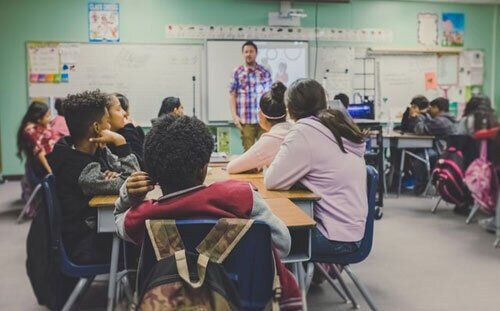 Students at desk Listening to Adventist Teacher Students in an Adventist operated educational institute which emphasizes the Evangelistic approach of the Church in education