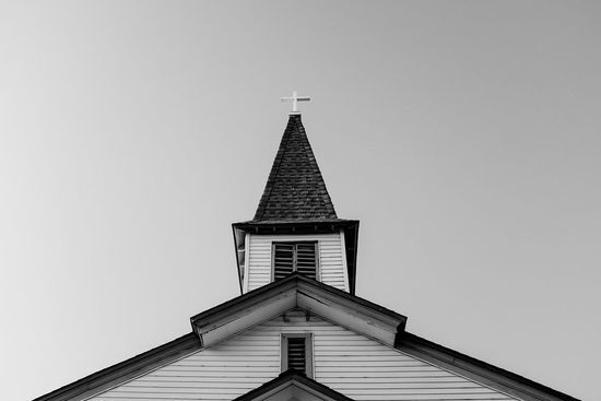 A silhouette of a man raising his arms to God and asking for victory over sin