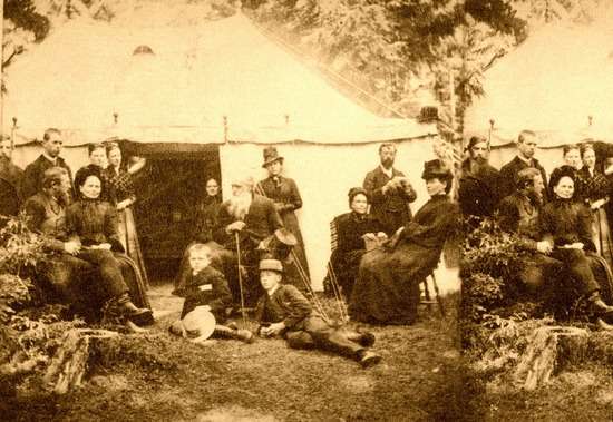 Tent at Campmeeting A black and white photo of people gathered outside a tent for a meeting.