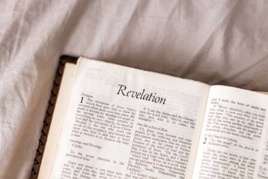 Open Bible in the Book of Revelation A Bible opened to the book of Revelation