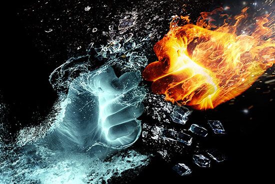 Hands of fire and water colliding and demonstrating the struggle of good versus evil