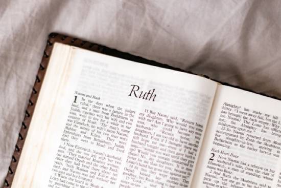 The Book of Ruth A Bible is opened to the first page of the Book of Ruth.