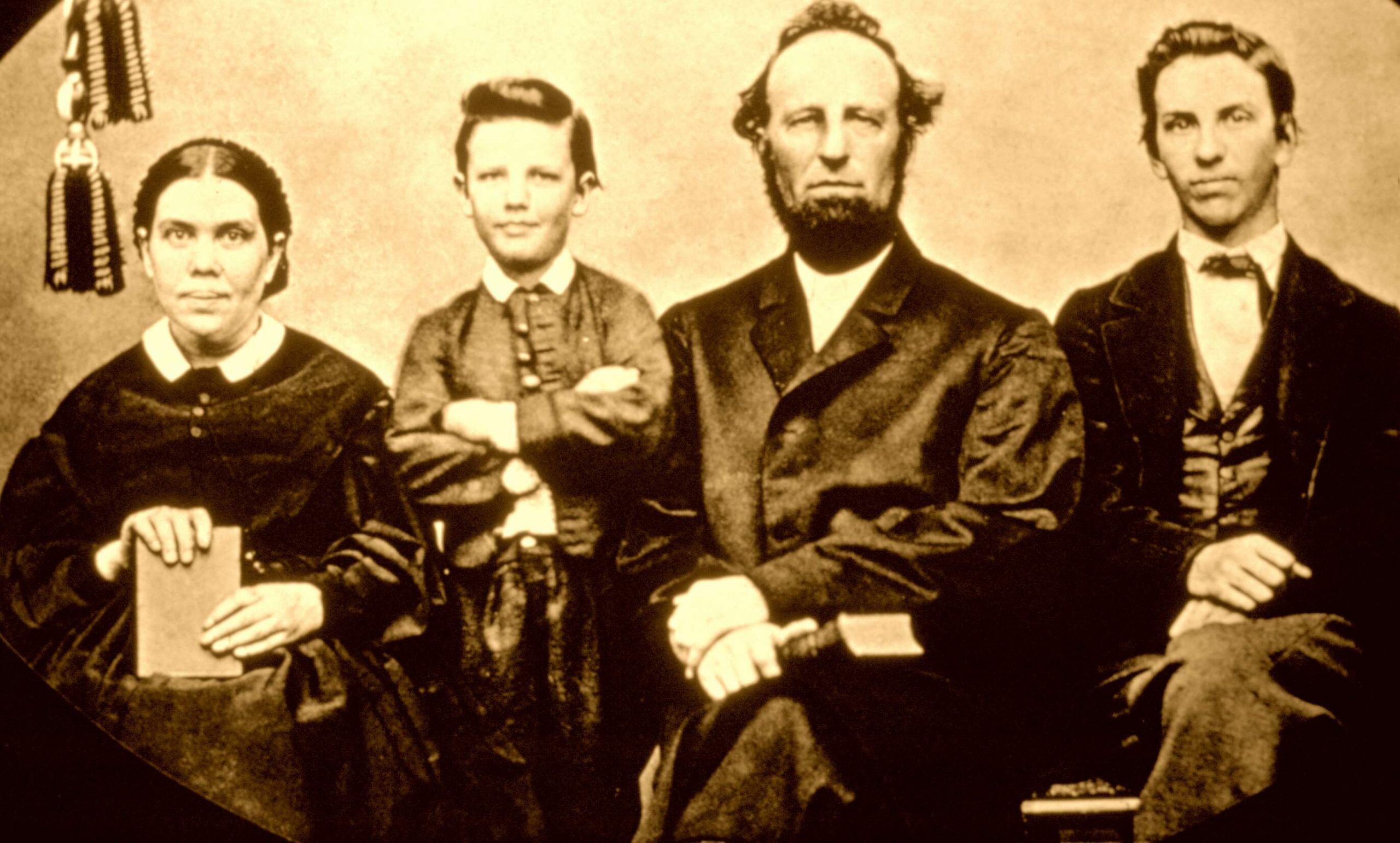 A family portrait of Ellen White, her husband, and her two sons.