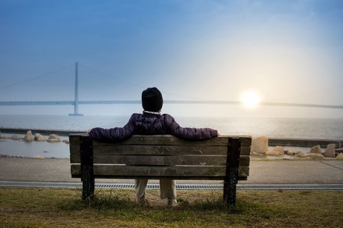 Person Sitting on Seashore Bench A person sitting on a bench, enjoying the peace of the Sabbath.