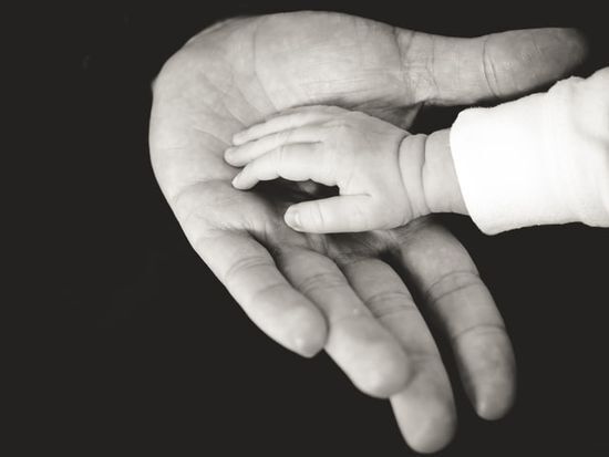 Child's hand in a parent's hand A child's hand in a parent's hand, illustrating how we can trust God