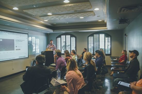 A man gives a presentation in front of a small audience.