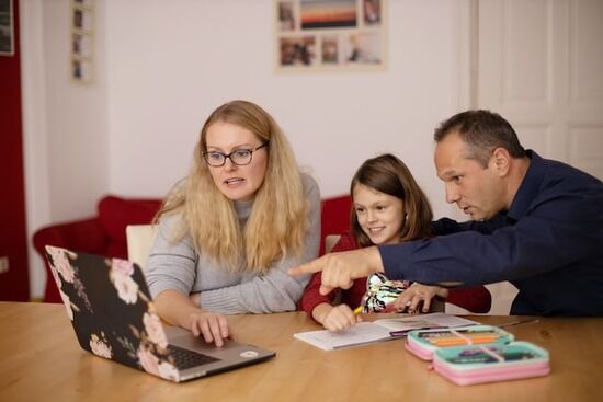 Parents helping daughter with homework Parents helping their daughter with homework