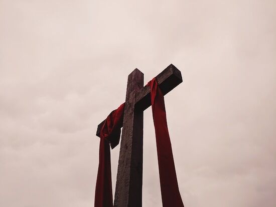A cross with a red cloth draped over it