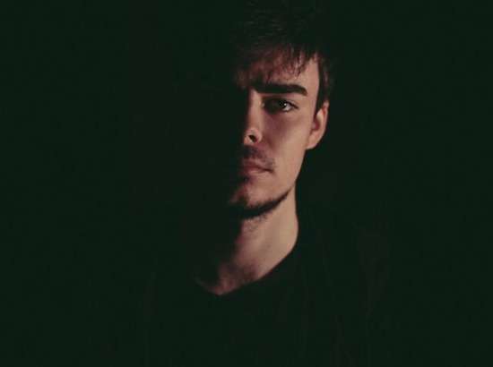 Man Dark Loyal to beast An image of a man against a dark backdrop. Half the man's face is shadowed, representing that following the beast results in a darkened heart.