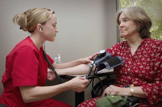 Nurse with Patient A nurse taking the blood pressure of a patient