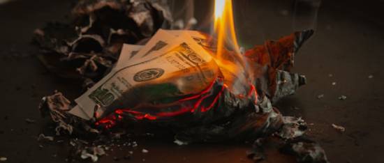 A small pile of burning $100 bills foreshadows how the prodigal son wasted his money on frivolous things.