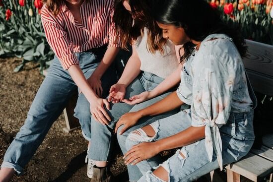 3 friends in prayer Three friends gathered together in intercessory prayer