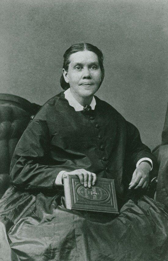 A portrait of Ellen White holding a book.