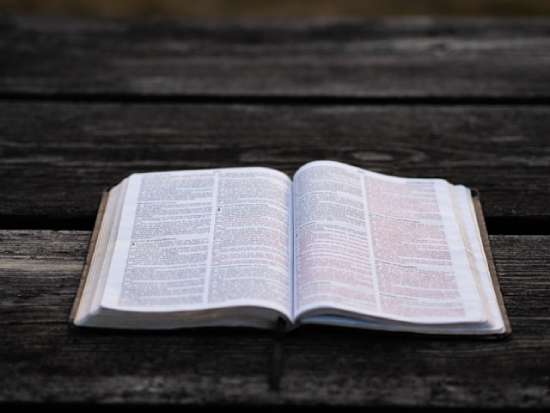 Open Bible A Bible open on a wooden table