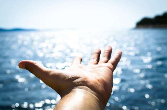 Hand Reaching Jesus Calling A hand reaching out toward the sun, the way someone might reach out to Jesus