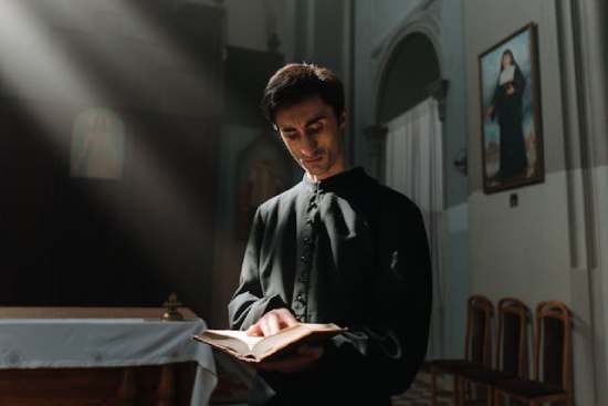 Priest reading bible A priest reading the Bible, showing how common people didn't have access to the Bible in the Dark Ages