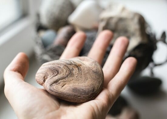 Stone in Hand A hand holding a rock, like the one thrown at Ellen White