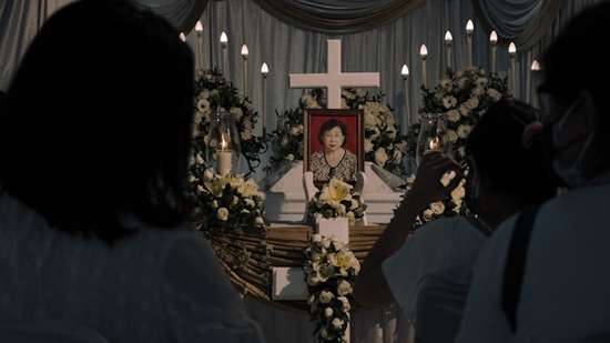 Casket of someone dead A casket decorated with flowers and a picture of the person who has died