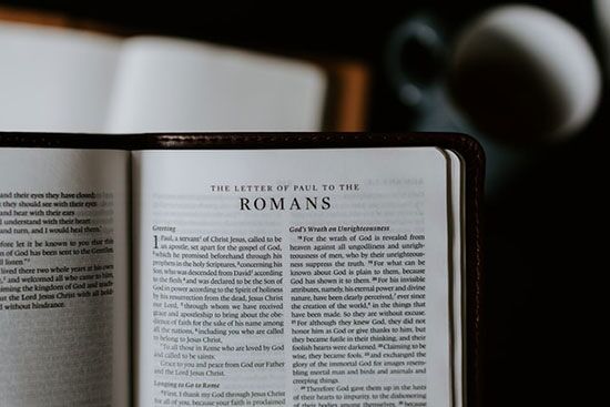 Bible Open to the Book of Romans A Bible open to the book of Romans, one of the letters Paul wrote