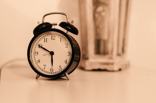 An alarm clock on a bedside table.