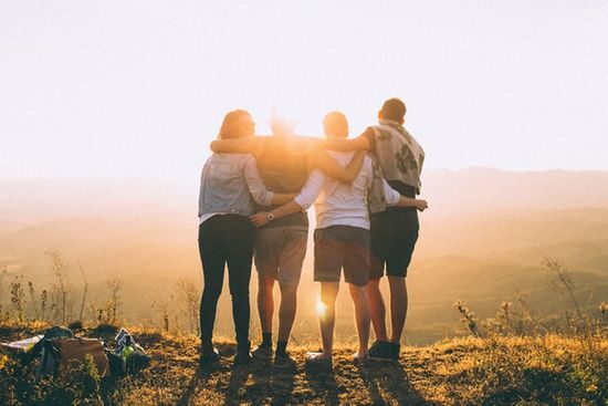 Friends watching sunset Friends with their arms around each other as they watch the sunset and enter the Sabbath hours