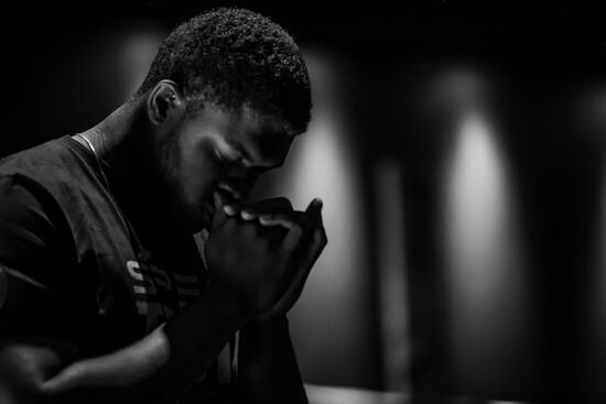 Man Praying A man praying and giving his life to Jesus Christ