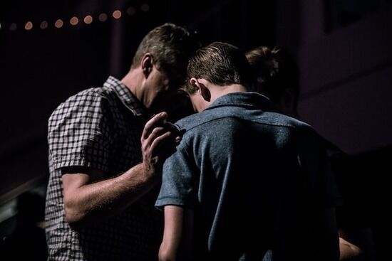 Men praying Young men praying together as we learn prayer is talking to God as to a close friend and opening of our hearts to Him