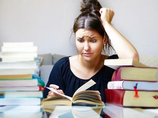 Woman reading books Woman reading books, as she is worried for her exam and we learn how worry pushes us to overcome challenges.