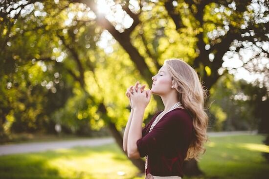 Woman praying A woman praying to Jesus and accepting Him as her Savior