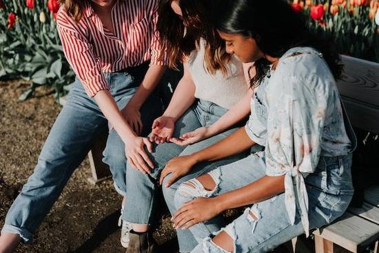 3 friends in prayer Three friends gathered together in intercessory prayer