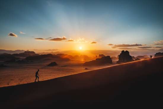 Man walking up Steep hill A person climbing a long mountain, emphasizing perseverance