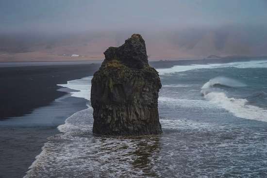 A large boulder standing firm on the shore, illustrating Peter's given name which meant 