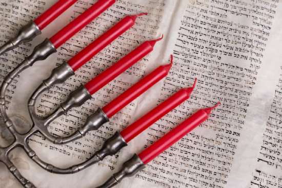 A menorah A menorah resting on top of old scrolls of the Bible