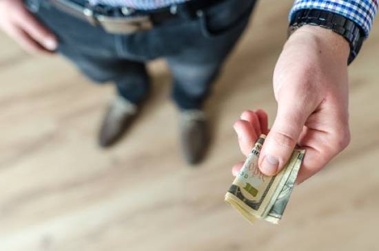 Person Holding Money in their Hand to Lend The image of someone lending cash reminds us that the Bible encourages lending. But it also has specific principles for how and when to do it.