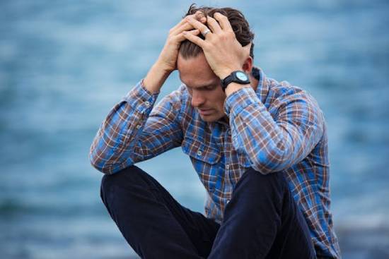 A Man Feeling Doubtful A man sits with his hands on his head, illustrating the thoughts and feelings we may have when we doubt.