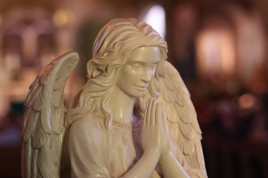 Statue of a praying angel A statue of a praying angel