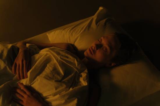 A woman lying in bed sleeping deeply A woman in peaceful slumber represents death as the Bible describes it—as a deep sleep with no thoughts or fears.