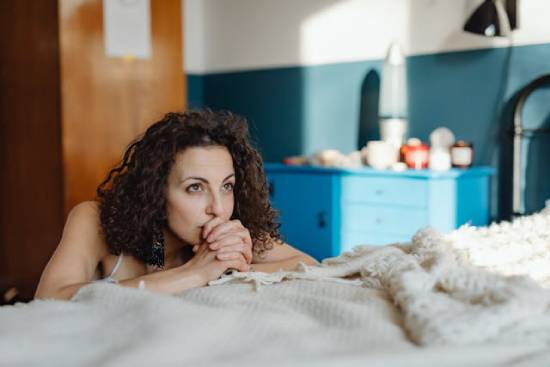 A woman praying by her bed A woman praying by her bed for her children