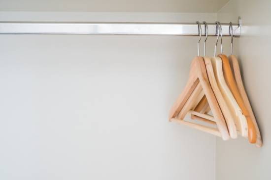 Empty clothes hangers A closet with empty clothes hangers, illustrating someone selling everything they have.