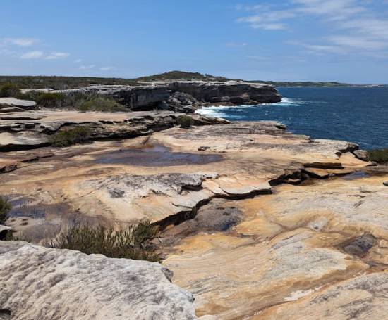 A beautiful scene of a rocky hillside next to the sea.
