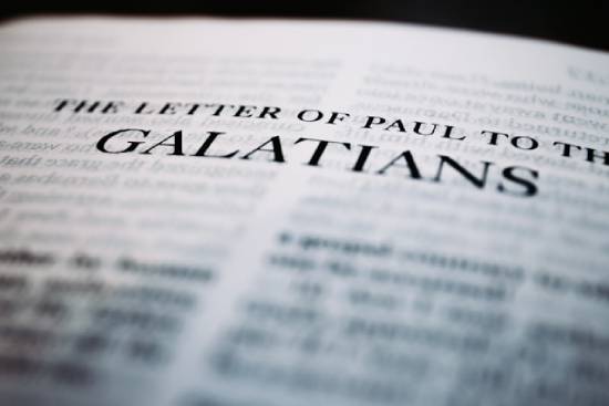 Text that reads The Letter of Paul to the Galatians A close-up of a page in the Bible titled Galatians
