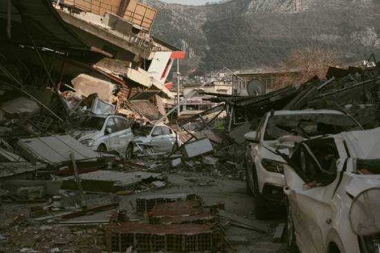 The aftermath of an earthquake A scene of ruin--demolished and crushed cars, buildings that have collapsed, a street that's so covered in destruction, you can't walk through it.