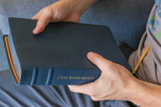 A Man holding the Bible.
