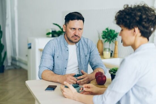 Husband and wife arguing at the table A man and his wife having an argument