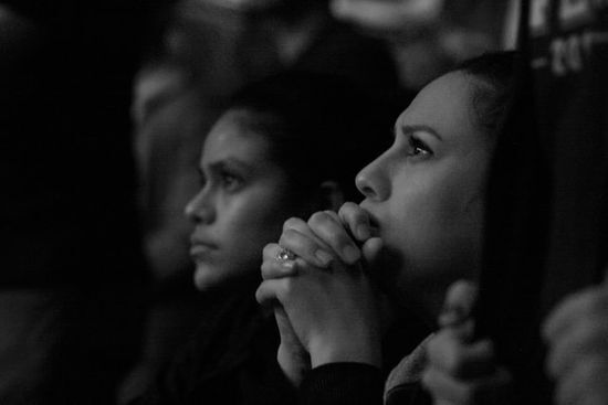 Women Praying Women praying with folded hands and open eyes as we study how Great Disappointment led Ellen White to further study of Bible.
