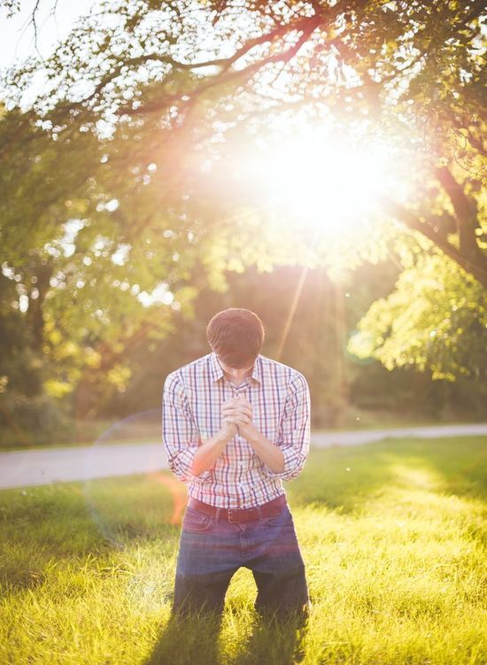 Man Praying Outside A man under a tree praying to God