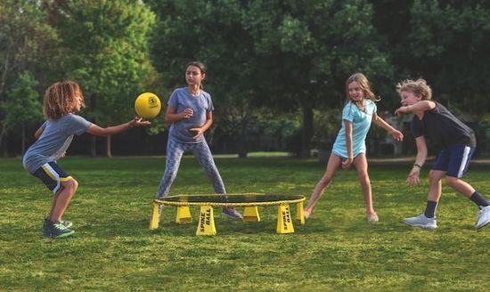 Children Playing Spike Ball Children playing a game of spike ball on the grass at a Christian camp
