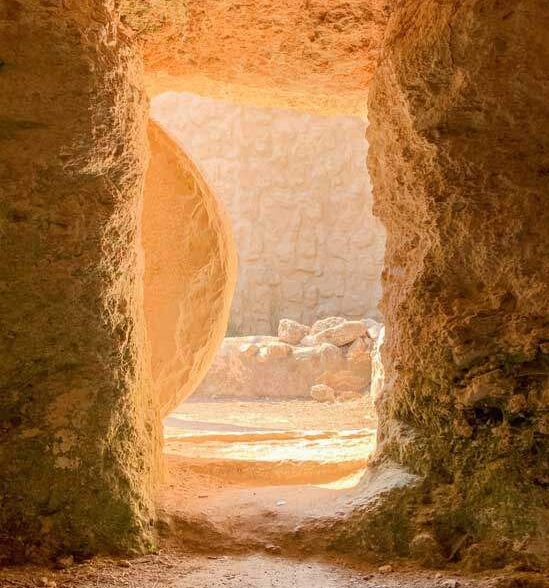A tomb with a stone rolled away from it, representing Jesus' resurrection from the dead