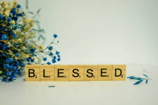 Scrabble tiles spelling out the word 'blessed.'