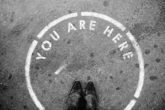 Person Standing in a Circle with the Words "You Are Here" A person standing in a circle that says "You are here." This reminds us to live one step at a time.